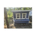 Front view of a blue Large Chicken Coop in a wooded customer yard