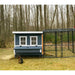 Blue Coastal OverEZ Large Chicken Coop and run in a wooded yard.