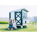 Two children beside a Farmhouse OverEZ Large Chicken Coop in a field.