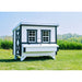 Farmhouse OverEZ Large Chicken Coop installed in a field beside a chicken run.