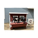 Two goats standing on the nesting box of a customer-installed red Large Chicken Coop