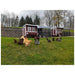 Two red OverEZ Large Chicken Coops with chicken runs and free-ranging chickens in a pasture.