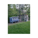 OverEZ XL Coastal chicken coop in a grassy, wooded yard connected to a customer-added enclosed run.