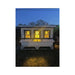 OverEZ XL Farmhouse chicken coop at night with yellow-lit windows and customer-added curtains and lights.
