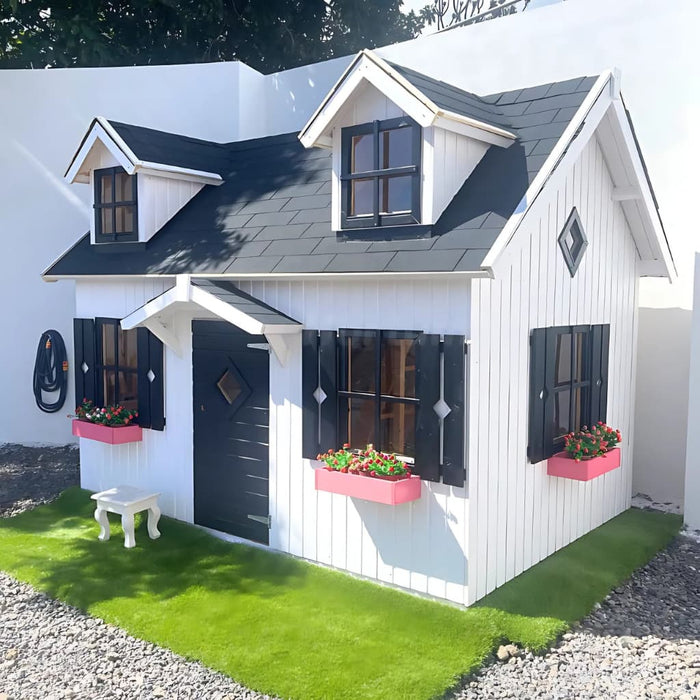 Small white palmako marie 9x6 playhouse with black shutters and pink flower boxes on a sunny day.