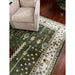 Cream and soft blue rug border beside a beige armchair