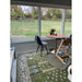 Royal Green and Ivory rug beneath a table beside large windows