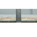 Side profile of the rug edge beside a ruler for visual scale