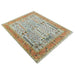 Angled full view of the rectangular Rust and Blue rug isolated on white with fringe visible