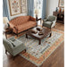 Styled living room showing the Rust and Blue rug beneath seating and a coffee table