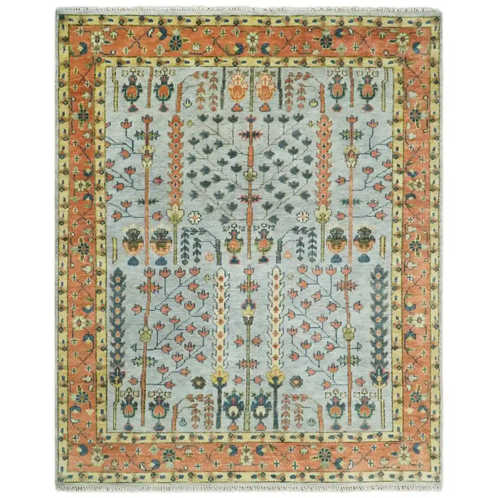 Front view of the full rectangular Rust and Blue Tree of Life rug on white with a pale blue-gray field, rust border, and fringe