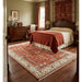 Rust and ivory Tree of Life rug styled on a bedroom floor beneath furniture.