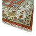 Rug corner showing the patterned border and fringe.
