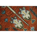 Close view of the rug’s pile and pattern beside a chair leg.