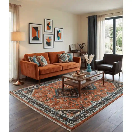 Rust, ivory and brown oriental rug styled in a living room beside a sofa and coffee table.