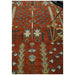 Close view of the rug’s central pattern beside a furniture leg.