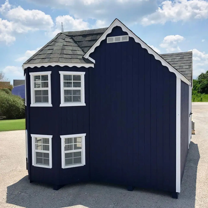 Navy blue Sara's Victorian Playhouse Kit with white trim on a clear day