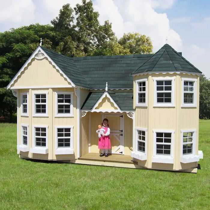 Little Cottage Co. Sara's Victorian Children's playhouse with a girl standing inside, surrounded by trees and grass.