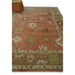 Hand-knotted Oushak rug segment in a styled room with furniture visible