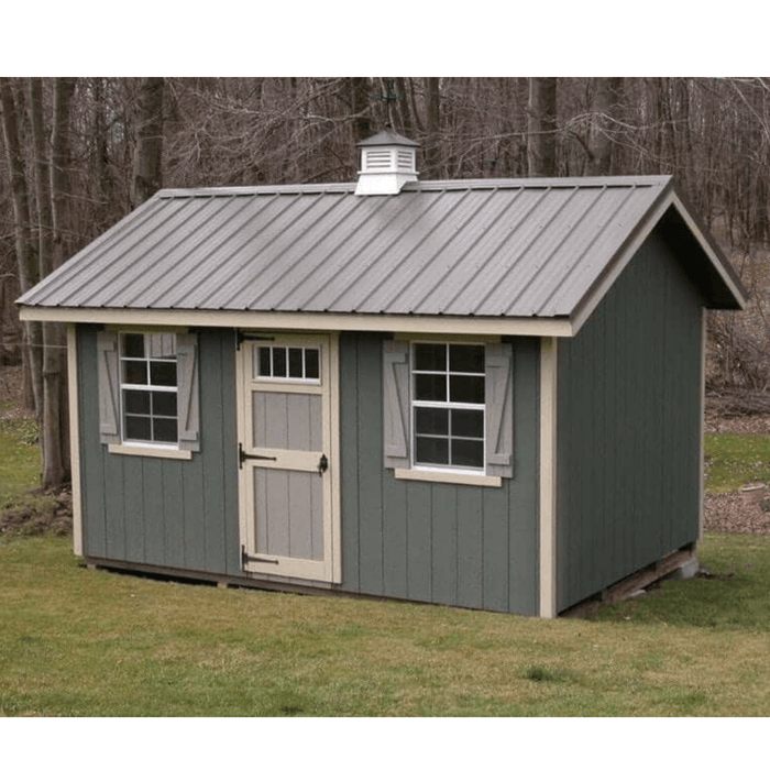 12x20 Riverside shed kit with green siding, beige trim, and a metal roof, featuring two windows and a single front door in a wooded backyard