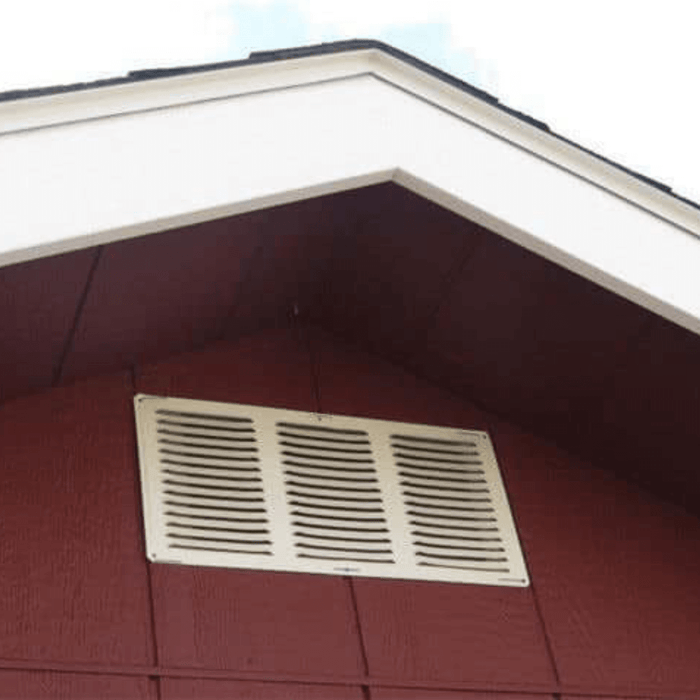 Close-up view of a roof vent on a red shed for improved airflow